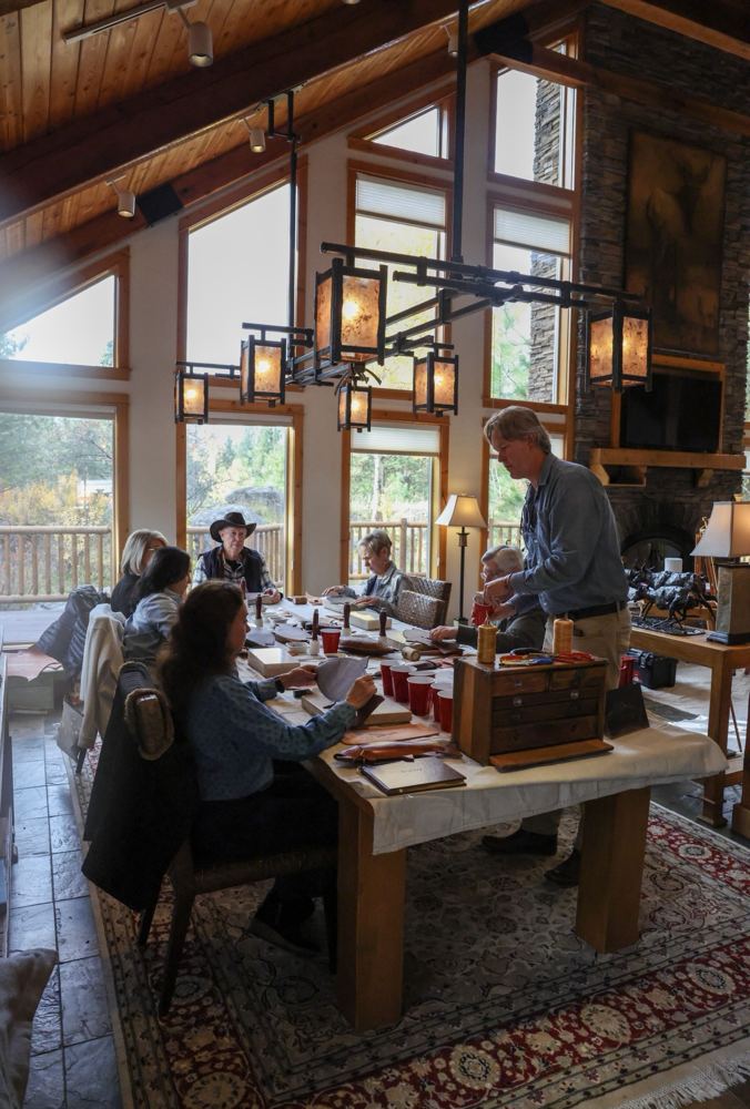 Workshop tables under iron chandeliers in a lodge great room